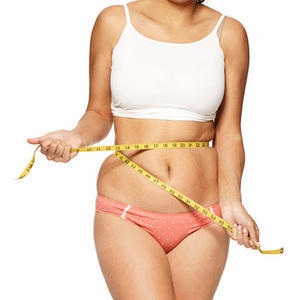 Overweight girl measures her waist